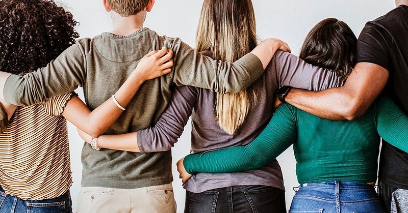 group of people interlocking arms