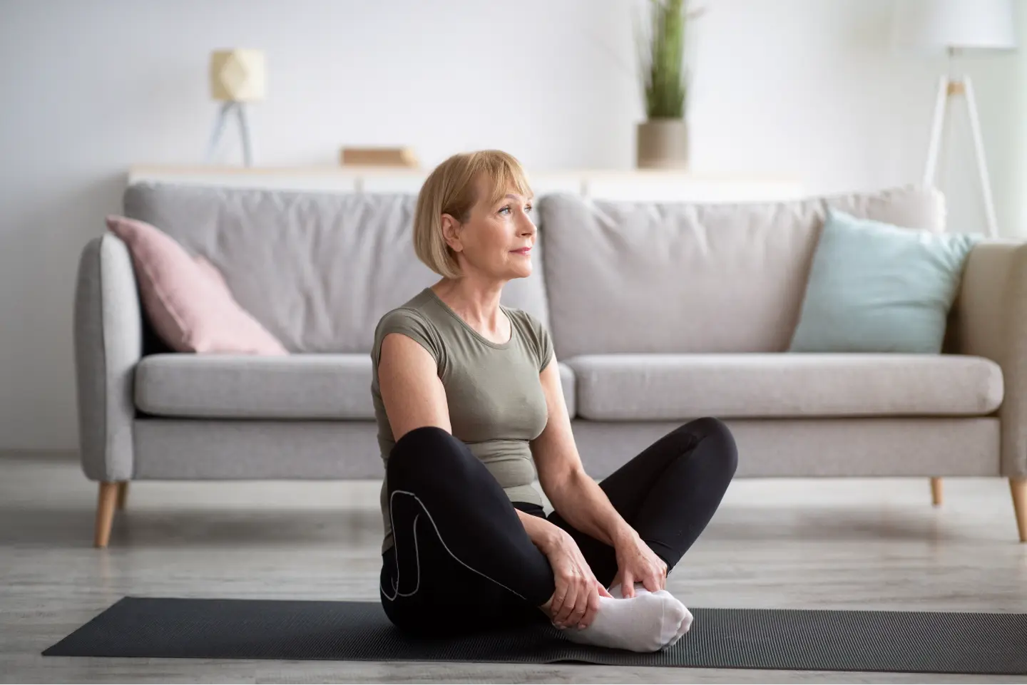 mature woman doing yoga in residence