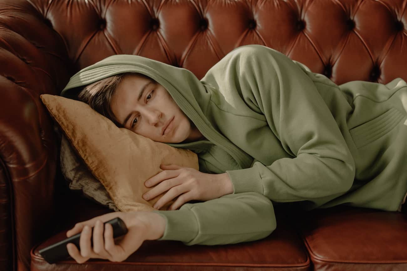 exhausted man laying out couch