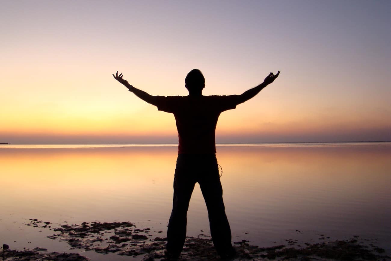 man embracing nature at the water