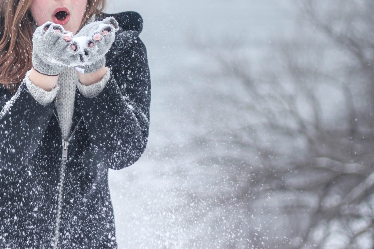 woman catching snow in her hands