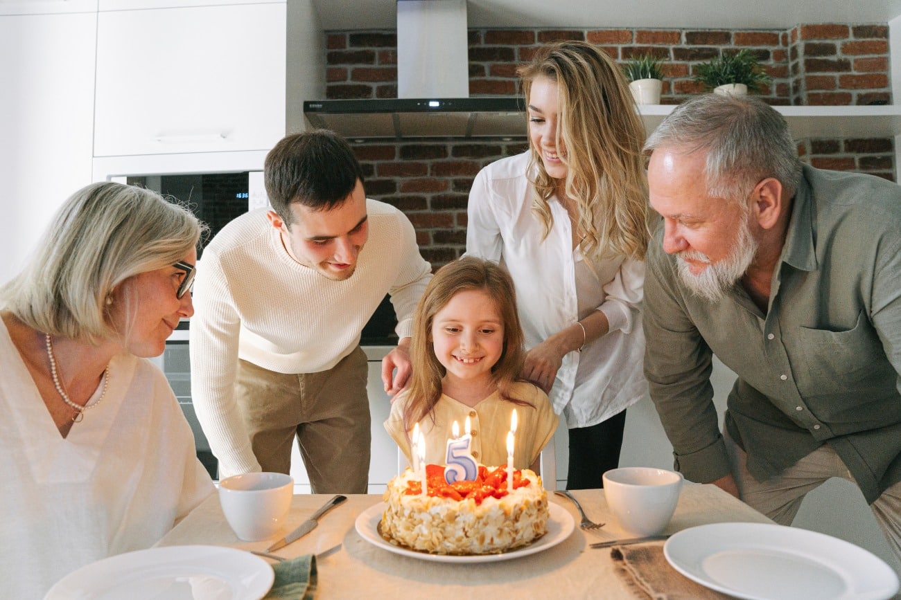 parents and grandparents with young child on birthday