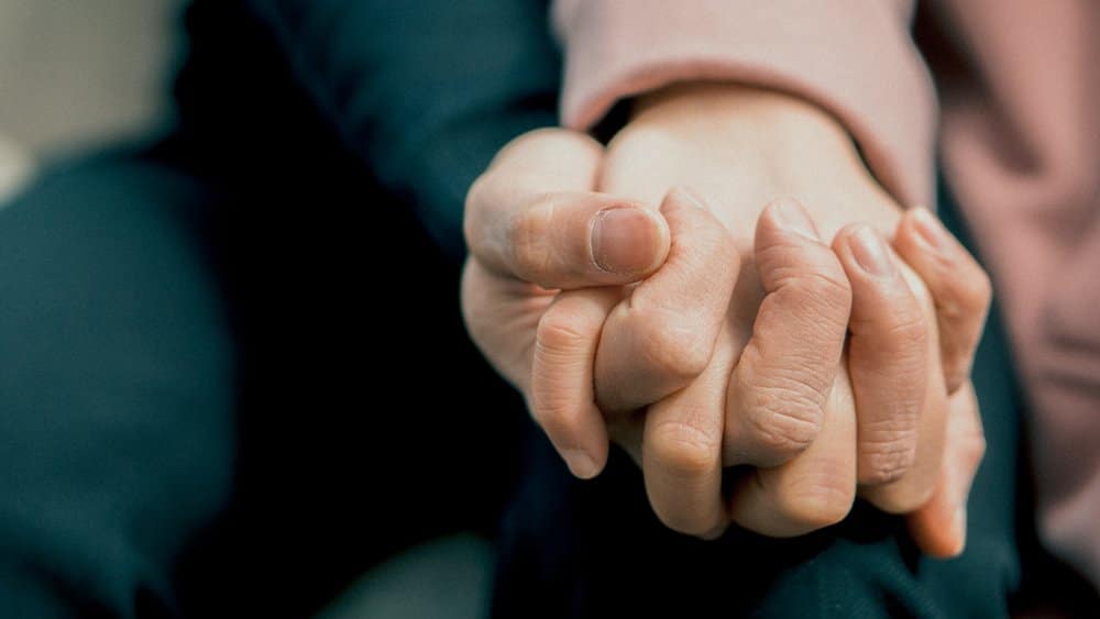 close up of couple holding hands