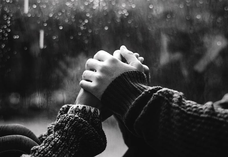 holding hands with a rain backdrop